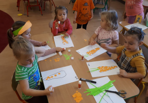dzieci wyklejają marchewkę